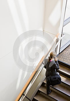 High angle view of businesswoman ascending stairs