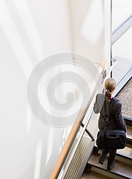 High angle view of businesswoman ascending stairs photo