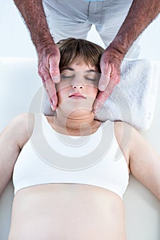 High angle view of calm woman receiving reiki treatment