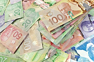 High Angle View of Canadian Banknotes of Different Values with a Large Stack of Bills on Top