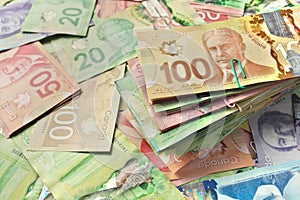 High Angle View of Canadian Banknotes of Different Values with a Large Stack of Bills on Top