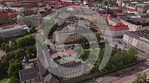 High angle view of cars driving on street near National Museum. Tilt up reveal color buildings in residential urban