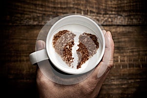Cup of cappuccino with a broken heart photo