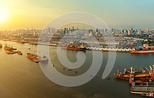 high angle view of chaopraya river and shipping dock against city scape of bangkok skyscraper