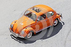 High angle view of a classic Volkswagen Beetle car driving on a road