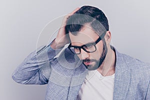 High angle view of confident handsome brunet in smart casual, glasses, standing on the pure background, fixing his perfect