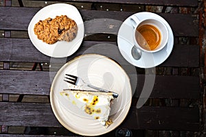 High angle view of coockies, cheesecake and a cup of coffee on a wooden table, Belgium