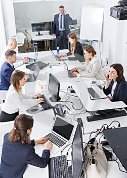 High-angle view of coworkers workin and communicating together