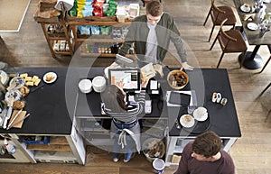 High angle view of customer at the counter of a coffee shop