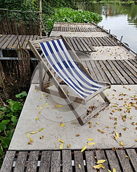 High angle view of deck chair at waterfront
