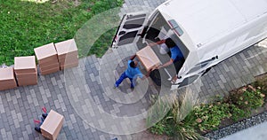 High Angle View Of Delivery Men Unloading The Cardboard Boxes