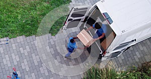 High Angle View Of Delivery Men Unloading The Cardboard Boxes