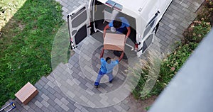 High Angle View Of Delivery Men Unloading The Cardboard Boxes