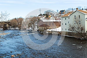 High angle view of the Du Loup river crossing a residential sector of town in winter