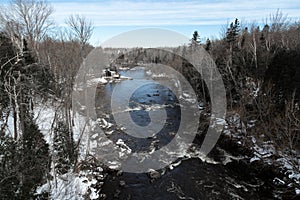 High angle view of the Du Loup river crossing town in winter