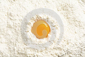 High angle view of egg yolk isolated on wheat flour background