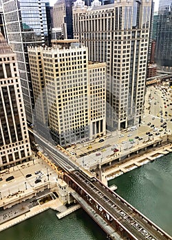 High angle view of el train passing over Chicago River in January morning in winter.