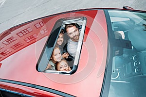 high angle view of family looking out of sunroof
