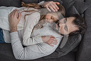 high angle view of father and daughter sleeping