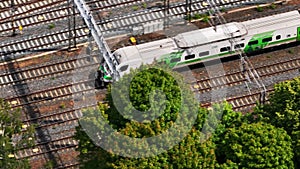 High angle view of Finnish Pendolino on multitrack railway line approaching station. Slowly moving high speed train