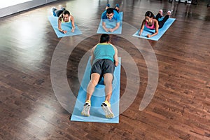 High-angle view of a fitness instructor during group calisthenics class