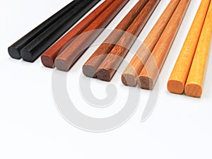 High angle view of five pairs wooden chopsticks are arranged isolated on white background.