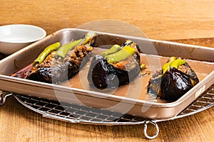 High angle view of freshly baked turkish food, turkey stuffed eggplants - karniyarik in tray metal ovenware