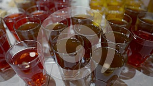 High angle view of glasses with juices standing in self-service restaurant. Healthful drinks in cafeteria indoors. No