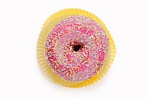 high angle view of a glazed pink donut with sugar sprinkles