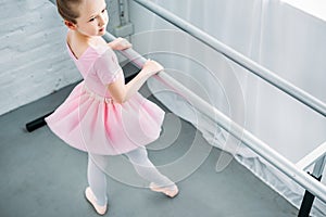 high angle view of graceful little ballerina exercising