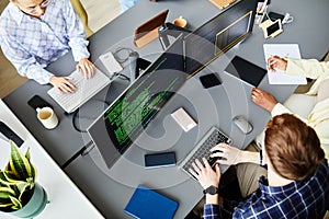 Programmers working on computers at office