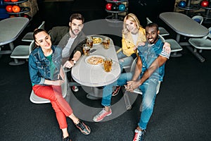 high angle view group of young friends spending time at bowling