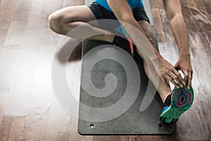 High-angle view of the hands of a man touching his toes as a str