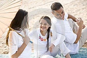 High angle view of happy Hispanic family on beach