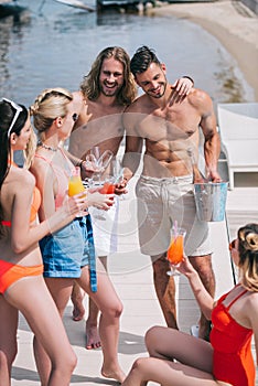 high angle view of happy young people drinking refreshing beverages