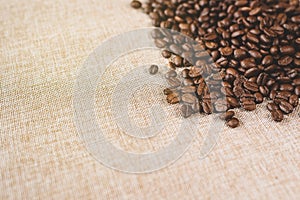 High angle view of a heap of a fresh rosted coffee beans on a burlap sack photo