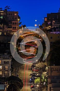 High angle view of illuminated homes on Lombard Street in San Francisco, California at sunset with car light trails