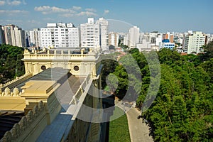 high angle view of Ipiranga Museum garden and building with Sao Paulo cityscape as backdrop, Brazil