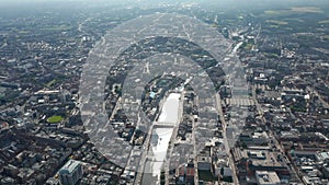 High angle view of large city. Aerial panoramic view of river flowing through town and reflecting sunshine. Dublin