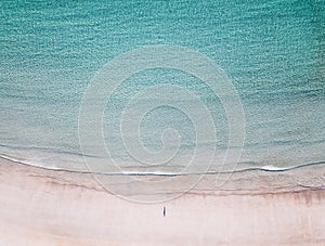 Aerial view of lonely man on the beach