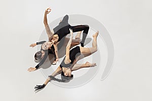 High angle view. Modern ballet performance. Group of modern dancers, art contemp dance, black and white, combination of