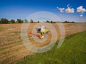 High Angle View modern combine harvester at the harvesting the wheat