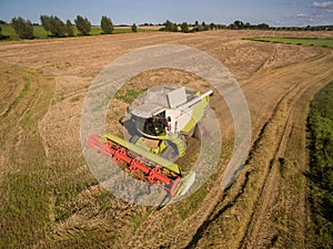 High Angle View modern combine harvester at the harvesting the wheat
