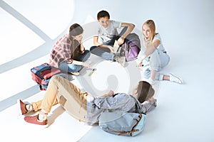 high angle view of multicultural group of students resting after classes together