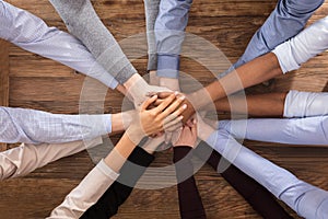 Multiracial Businesspeople Stacking Their Hands photo