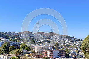 High angle view of a neighborhood with dense residential buildings near the cell tower on a mountain