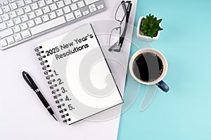 High angle view of 2025 New Year\'s Resolutions text on notepad photo