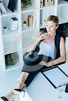 high angle view of pensive adult businesswoman