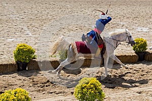 High angle view of a person sitting on the horse that is running on the sand