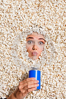 High angle view photo of girl arm hold soda drink can sip straw face buried in full with popcorn background